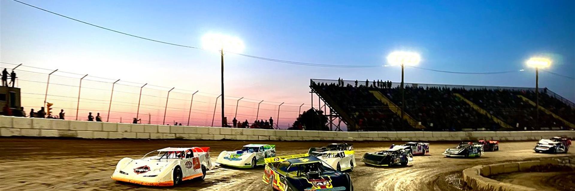 cars on race track at dusk