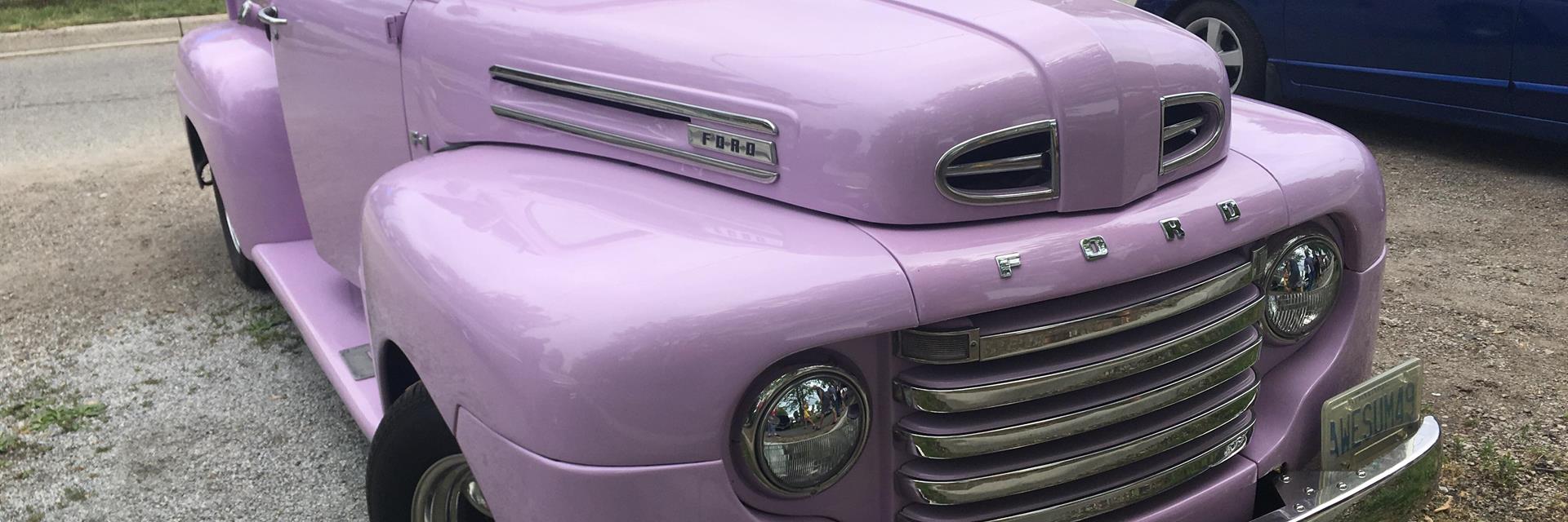 a purlple classic truck parked on the grass at a car show in chatham-kent 