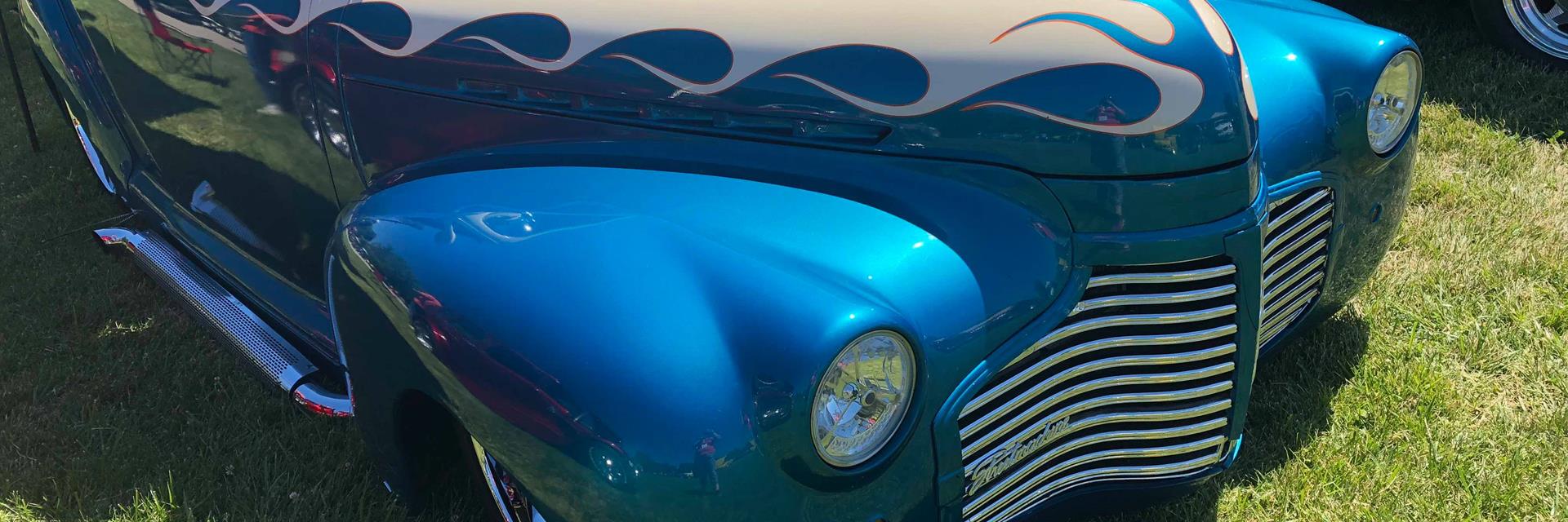 a blue and silver classic car on display at a classic car show in chatham-kent